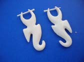 Handmade organic bone earring in crafted art image