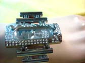 Flashing silver and gemstone framed wrist watch with two tiers on top and bottom