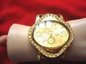 G & Q contemporary oval framed watch in gold with large numbers and burgundy imitation leather strap