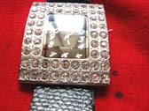 Large stone inlaid silver framed watch with black imitation leather strap 