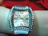 Dali inspired quartz clock face on silver fashion watch with cz gems along frame