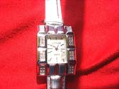 Spring Guess designed ladies evening watch with pink tinted strap and rectangle shaped clack frame 