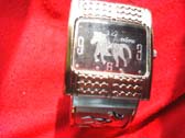 Black bangle bracelet watch with a variety of sized cz gems on strap