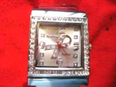 Cancer ribbon symbol in clock face of silver watch with stones around frame 