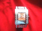 Ladies silver watch with squared spiral design frame and vintage etchings bangle bracelet