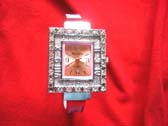 Pink tinted thin strap holding double square framed fancy watch