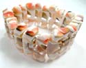 Fashion bracelet with long irregular shape dyed seashell in orange, green and pink design