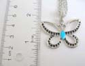 Fashion necklace holding a cut-out butterfly in black and blue enamel design, lobster clasp