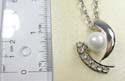 Fashion necklace with silver plated extension chain and lobster clasp, holding an imitation pearl pendant paired with multi mini clear cz on side