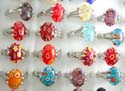 Fashion ring with triple bands on both sides holding oval handmade Milleflori flower (thousand of flower) glass