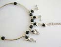 Fashion slave bangle-ring with black rounded rhinestones embedded and multi silvery moon decor dangling 